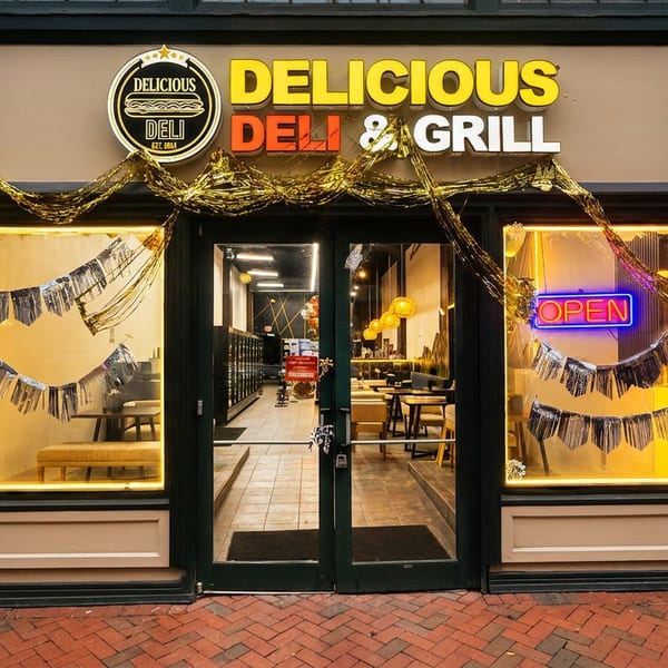 Exterior of Delicious Deli & Grill with festive gold and silver decorations and an "OPEN" sign.